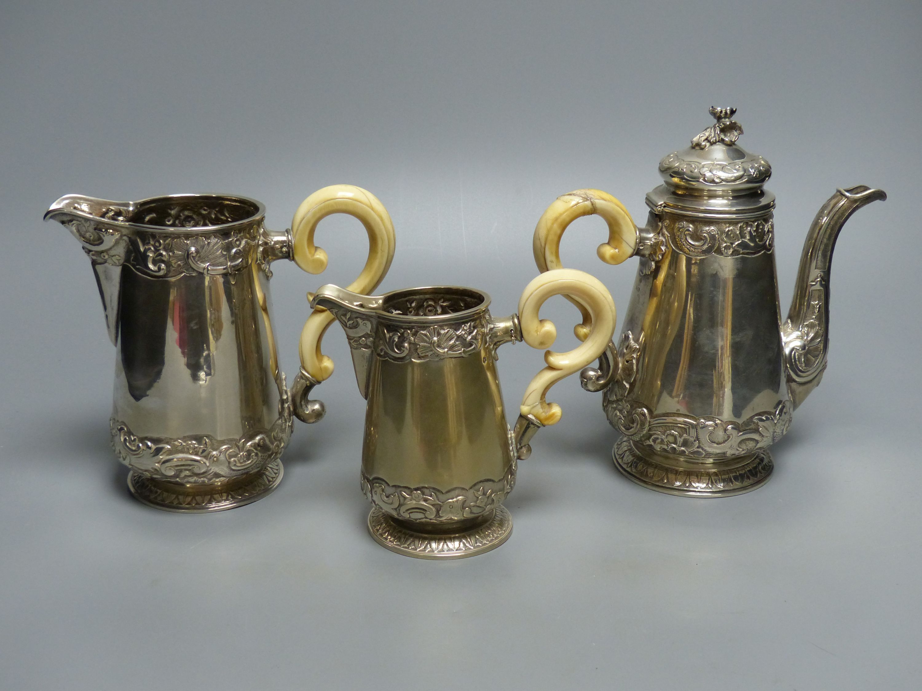 A late 19th/early 20th century Austro-Hungarian embossed 800 standard white metal three piece tea set, gross 35oz,